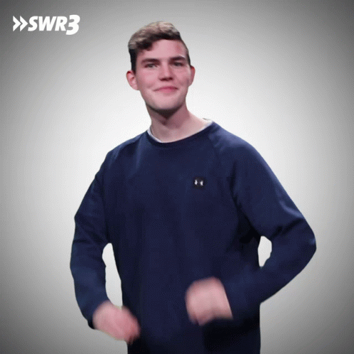 A Man Wearing A Blue Under Armour Sweatshirt Is Dancing In Front Of A Swr3 Logo GIF
