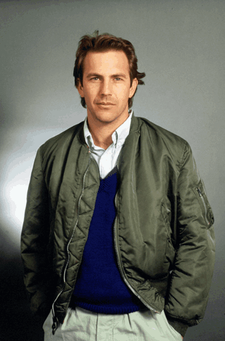 A Man Wearing A Bomber Jacket And A Blue Sweater GIF