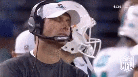 A Man Wearing A Bose Headset Is Watching A Football Game On Cbs . GIF