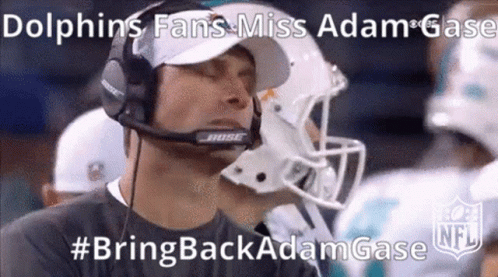 A Man Wearing A Bose Headset Is Watching A Football Game .. GIF