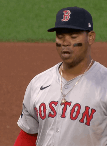 A Man Wearing A Boston Jersey And A Hat With The Letter B On It GIF