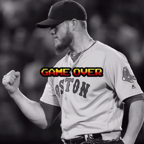 a man wearing a boston jersey holds his fist up in celebration