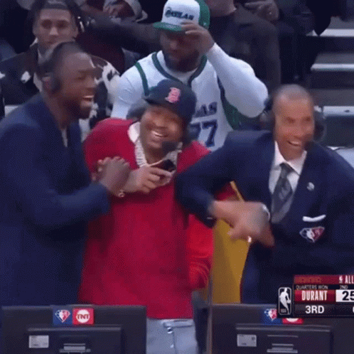 A Man Wearing A Boston Red Sox Hat Is Laughing While Sitting In Front Of A Tnt Sign GIF