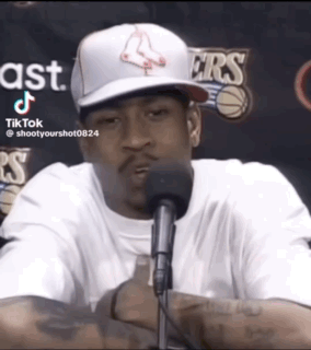 A Man Wearing A Boston Red Sox Hat Is Sitting In Front Of A Microphone GIF