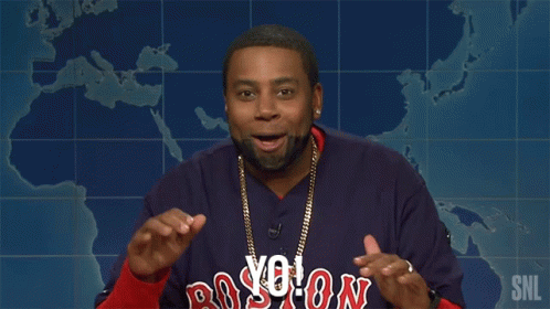 a man wearing a boston red sox jersey is giving a speech