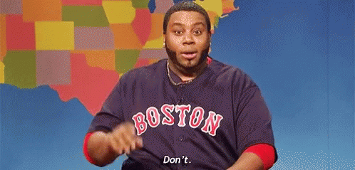 a man wearing a boston red sox jersey is making a funny face and saying `` don 't '' .
