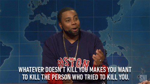 a man wearing a boston shirt is talking