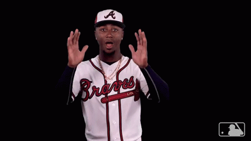 A Man Wearing A Braves Jersey Is Making A Funny Face GIF