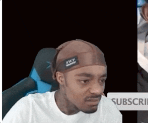 A Man Wearing A Brown Headband Is Sitting In A Chair . GIF