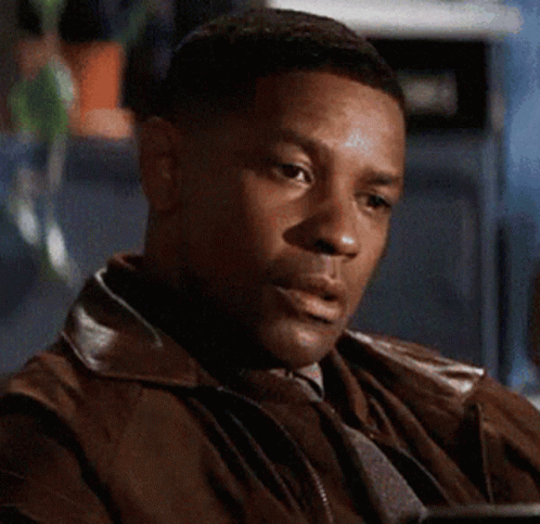 A Man Wearing A Brown Leather Jacket Is Sitting At A Table GIF