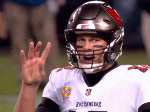 A Man Wearing A Buccaneers Jersey Is Waving GIF