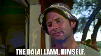 A Man Wearing A Bucket Hat Is Standing In Front Of A Building And Says `` The Dalai Lama , Himself . '' GIF