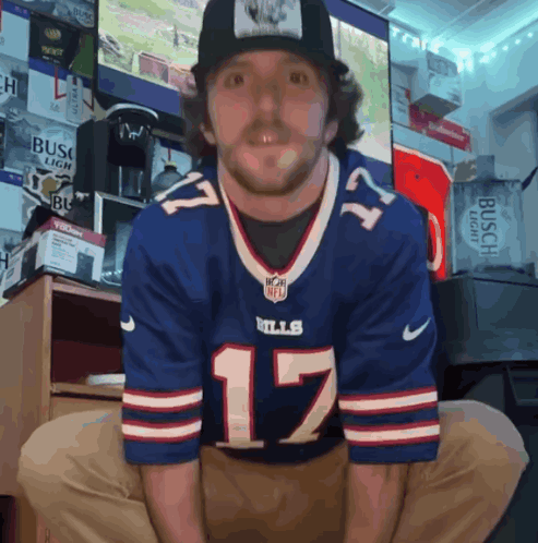 A Man Wearing A Buffalo Bills Jersey And A Hat GIF