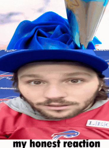 a man wearing a buffalo bills jersey has a blue rose on his head