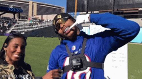 A Man Wearing A Buffalo Bills Jersey Is Giving A Thumbs Up Sign GIF