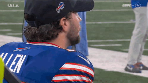 A Man Wearing A Buffalo Bills Jersey Looks To The Side GIF