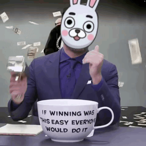 A Man Wearing A Bunny Mask Is Sitting In Front Of A Cup That Says If Winning Was This Easy Everyone Would Do It GIF