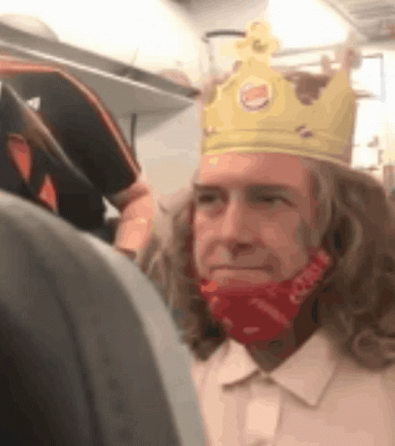 A Man Wearing A Burger King Crown And A Red Face Mask GIF