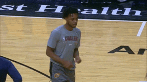 A Man Wearing A Cavaliers Shirt Stands On A Basketball Court GIF