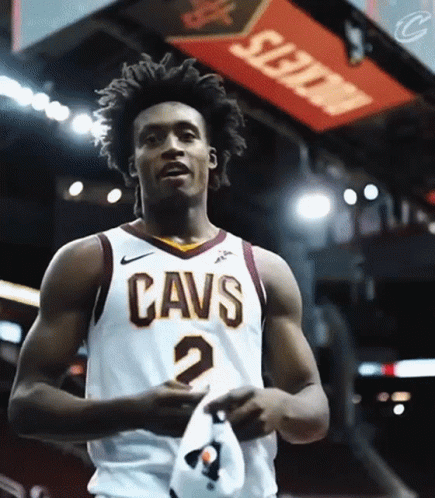 A Man Wearing A Cavs Jersey Holds A Hat GIF