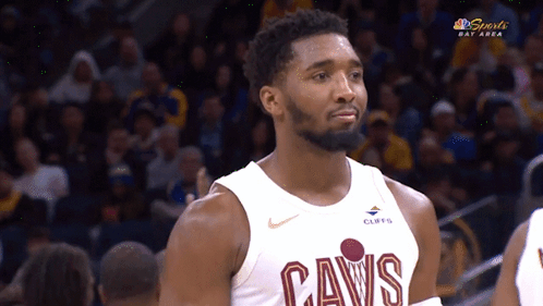 A Man Wearing A Cavs Jersey Looks At Something GIF