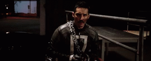 A Man Wearing A Chain Around His Neck Has The Number 7 On His Chest GIF