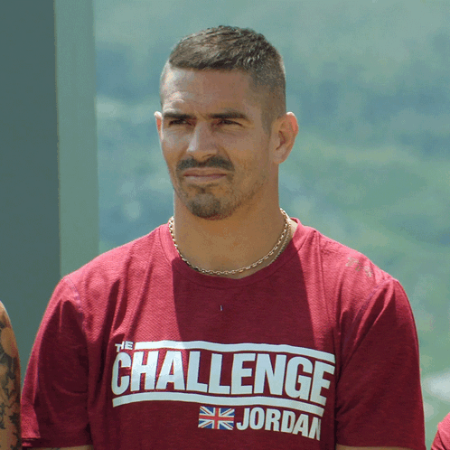A Man Wearing A Challenge Jordan Shirt Looks At The Camera GIF