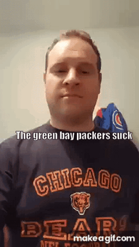 a man wearing a chicago bears shirt is making a funny face .