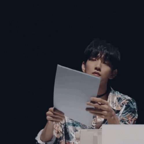 A Man Wearing A Choker And A Shirt With The Letter E On It GIF