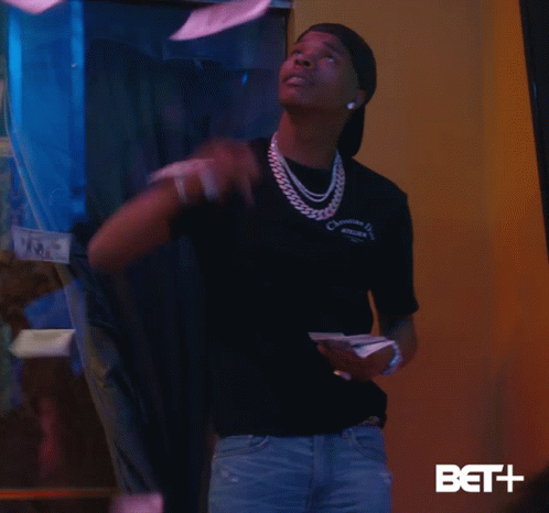A Man Wearing A Christian Dior T-Shirt Throws Money In The Air GIF