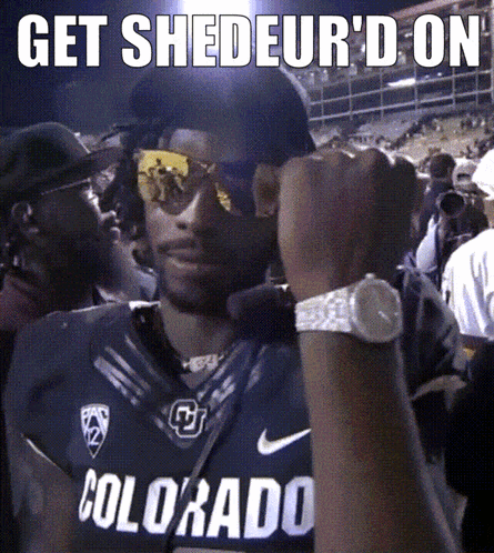 A Man Wearing A Colorado Jersey Holds His Fist In The Air GIF