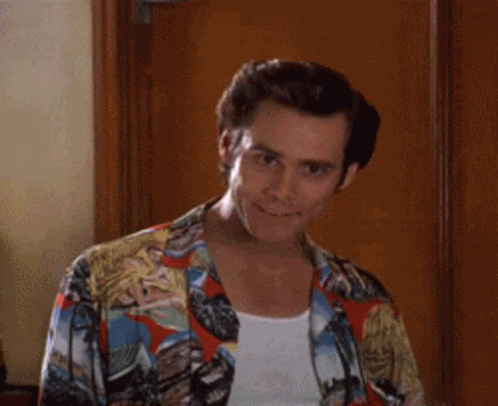 A Man Wearing A Colorful Shirt Is Smiling And Giving A High Five . GIF