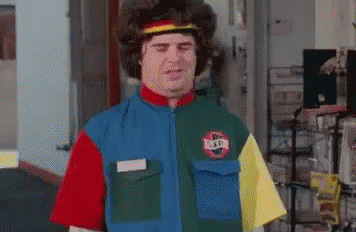 A Man Wearing A Colorful Shirt With A Nike Logo On It Is Standing In A Room . GIF