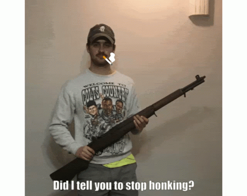 A Man Wearing A Colts Country Shirt Holds A Rifle GIF