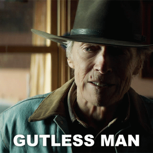 A Man Wearing A Cowboy Hat And A Jacket With Gutless Man Written On It GIF