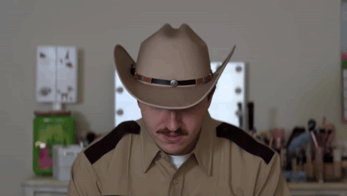 A Man Wearing A Cowboy Hat And A Police Uniform Says Thought GIF