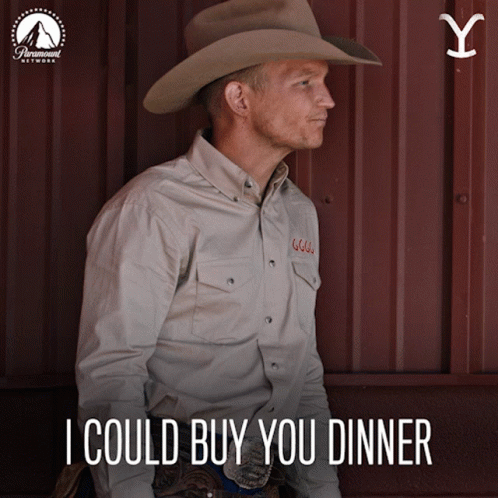 A Man Wearing A Cowboy Hat And A Shirt That Says I Could Buy You Dinner GIF
