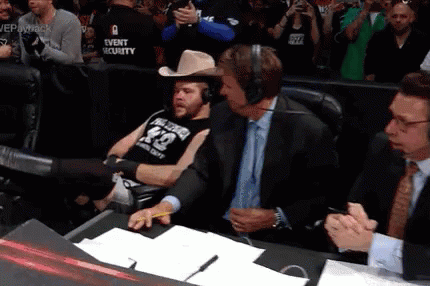 A Man Wearing A Cowboy Hat And A Shirt With The Number 42 On It Sits In A Chair GIF