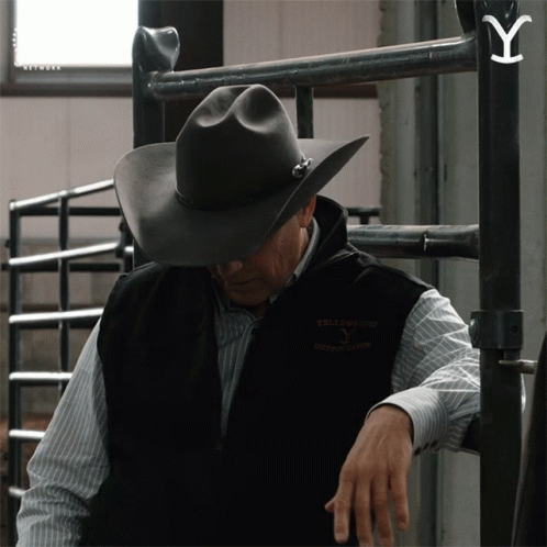 A Man Wearing A Cowboy Hat And A Vest That Says Yellowstone GIF