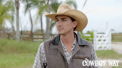 A Man Wearing A Cowboy Hat And A Vest With The Cowboy Way Written On The Bottom GIF
