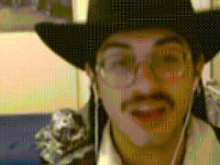 A Man Wearing A Cowboy Hat And Glasses Is Talking GIF