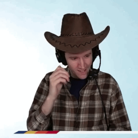 A Man Wearing A Cowboy Hat And Headphones Talks On A Phone GIF