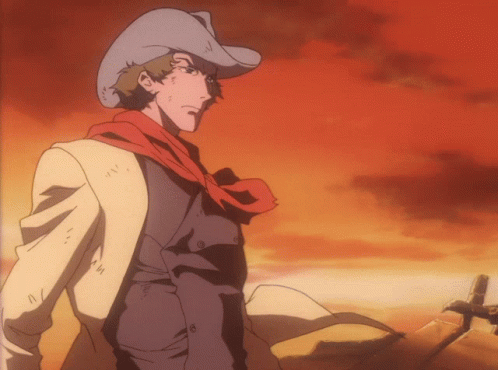 A Man Wearing A Cowboy Hat And Scarf Is Standing In The Desert GIF