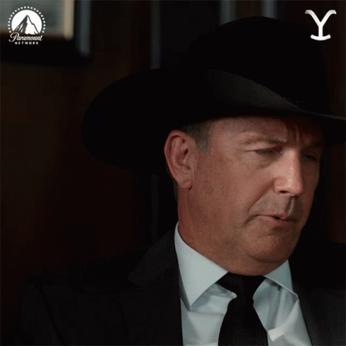 A Man Wearing A Cowboy Hat And Tie Is Pointing Up With A Paramount Network Logo In The Background GIF