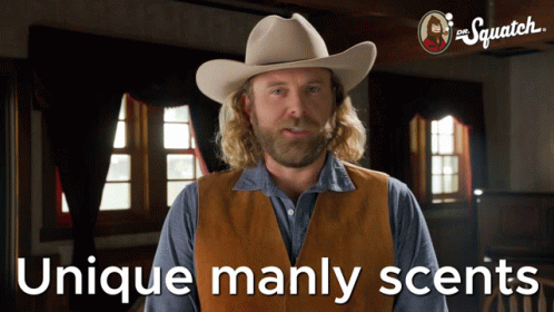A Man Wearing A Cowboy Hat And Vest With The Words Unique Manly Scents Below Him GIF