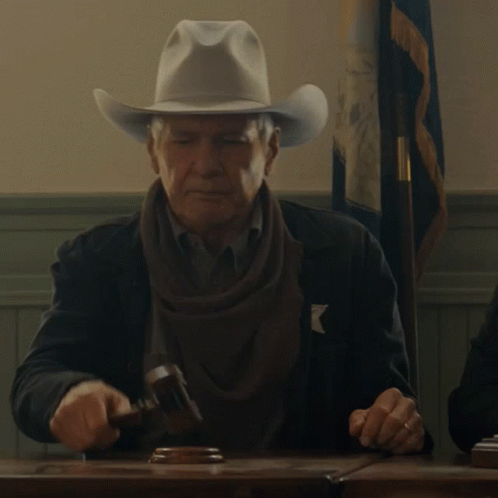 A Man Wearing A Cowboy Hat Holds A Hammer GIF