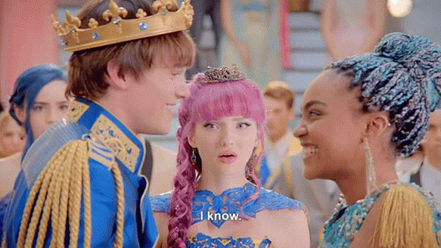 A Man Wearing A Crown Is Standing Next To A Woman With Pink Hair And A Girl With Blue Hair . GIF
