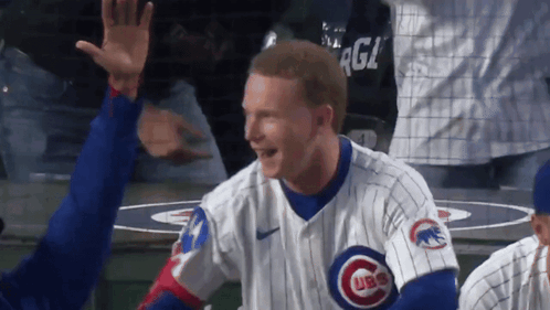A Man Wearing A Cubs Jersey High Fives Another Player GIF