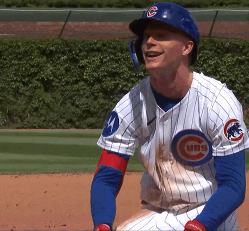 A Man Wearing A Cubs Jersey Is Smiling On The Field GIF