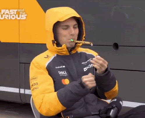 A Man Wearing A Dell Jacket Is Blowing A Party Horn GIF